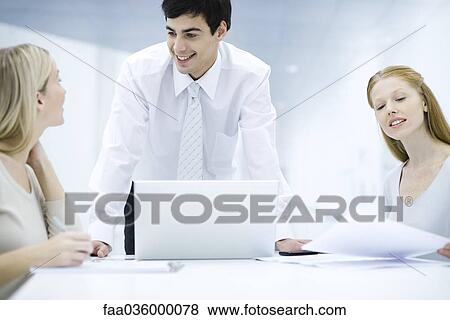 Professionals working at desk View Large Photo Image Stock Photo - Professionals working at desk. Fotosearch