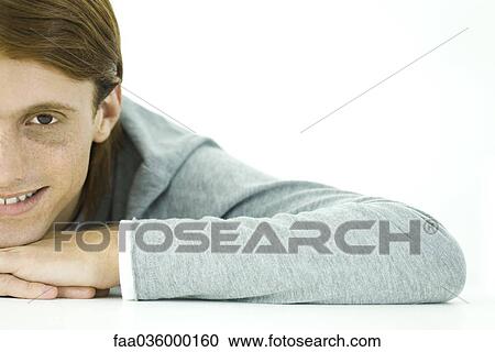 Red-haired man resting chin on hands, smiling at camera, cropped View Large Photo Image Stock Image - Red-haired man resting chin on hands, smiling at camera, cropped. Fotosearch