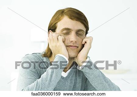 Red-haired man resting chin on hands, eyes closed View Large Photo Image Stock Photo - Red-haired man resting chin on hands, eyes closed. Fotosearch