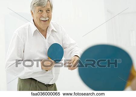 Senior man playing table tennis, smiling View Large Photo Image Stock Photography - Senior man playing table tennis, smiling. Fotosearch