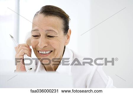 Senior woman using landline phone, smiling View Large Photo Image Stock Image - Senior woman using landline phone, smiling. Fotosearch