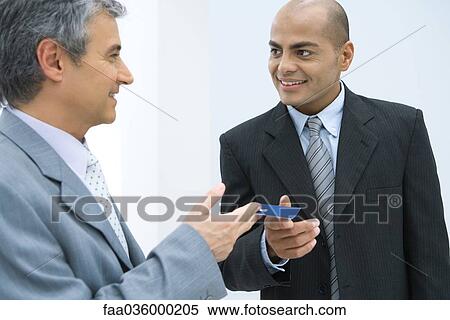 Stock Photography - Two businessmen exchanging business card. Fotosearch