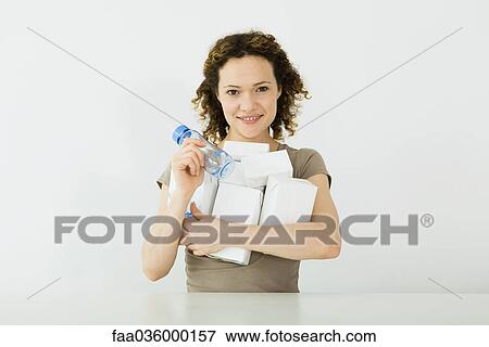 Woman holding an armful of milk cartons and baby bottle, smiling at camera View Large Photo Image Stock Photo - Woman holding an armful of milk cartons and baby bottle, smiling at camera. Fotosearch