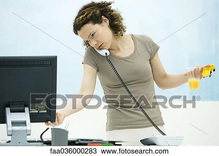 Woman multitasking in office View Large Photo Image Stock Image - Woman multitasking in office. Fotosearch