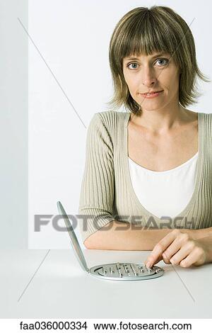 Woman playing peg solitaire game, smiling at camera View Large Photo Image Picture - Woman playing peg solitaire game, smiling at camera. Fotosearch
