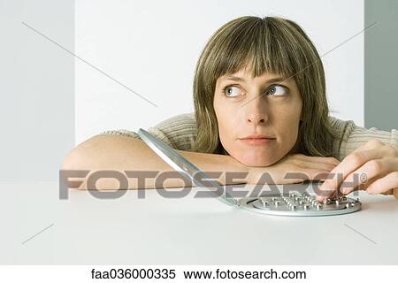 Woman resting head on arms, playing peg solitaire game, looking away View Large Photo Image Stock Photography - Woman resting head on arms, playing peg solitaire game, looking away. Fotosearch