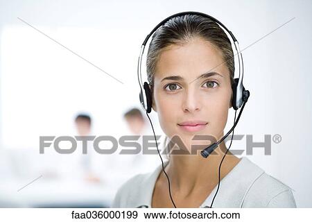 Woman wearing headset, looking at camera, portrait View Large Photo Image Stock Photo - Woman wearing headset, looking at camera, portrait. Fotosearch