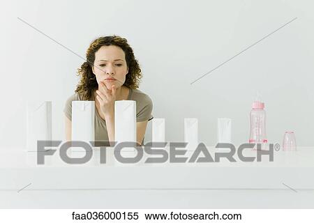 Woman with milk cartons and baby bottle, hand under chin View Large Photo Image Stock Photography - Woman with milk cartons and baby bottle, hand under chin. Fotosearch