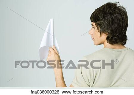 Young man holding white flag, rear view View Large Photo Image Stock Photograph - Young man holding white flag, rear view. Fotosearch