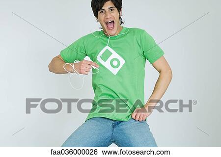 Young man listening to MP3 player, dancing, smiling at camera View Large Photo Image Stock Photograph - Young man listening to MP3 player, dancing, smiling at camera. Fotosearch