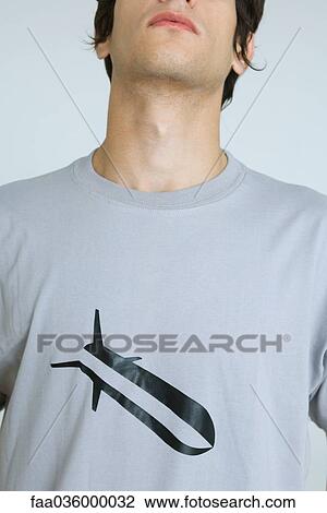 Young man wearing tee-shirt with bomb graphic, cropped View Large Photo Image Stock Image - Young man wearing tee-shirt with bomb graphic, cropped. Fotosearch