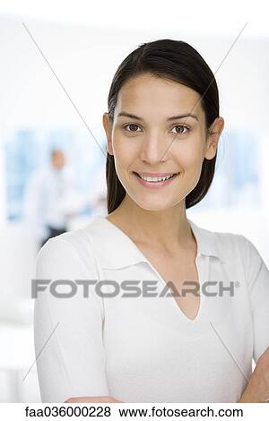 Young professional woman smiling at camera, portrait View Large Photo Image Stock Photo - Young professional woman smiling at camera, portrait. Fotosearch