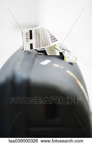 Airline label attached to suitcase handle, close-up View Large Photo Image Stock Photograph - Airline label attached to suitcase handle, close-up. Fotosearch