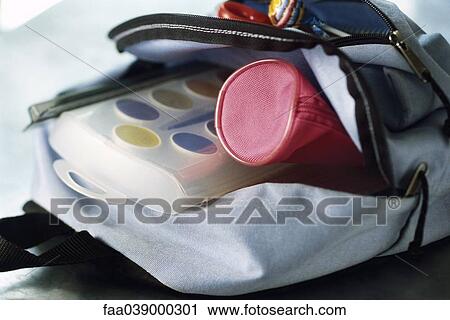 Stock Image - Backpack containing pencil case and watercolor paints. Fotosearch