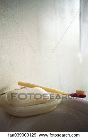 Bar of soap in soap dish, toothbrush lying alongside View Large Photo Image Stock Photo - Bar of soap in soap dish, toothbrush lying alongside. Fotosearch