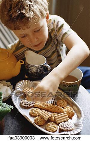 Boy having snack View Large Photo Image Stock Image - Boy having snack. Fotosearch