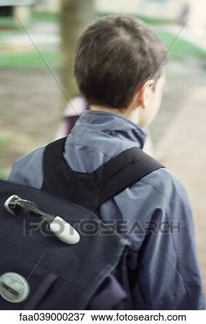 Boy wearing backpack, rear view View Large Photo Image Stock Photo - Boy wearing backpack, rear view. Fotosearch