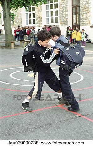 Boys fighting on school playground View Large Photo Image Stock Photo - Boys fighting on school playground. Fotosearch