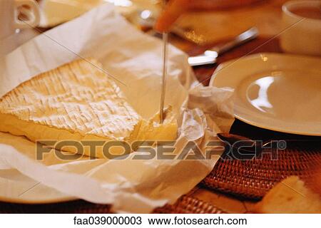 Stock Image - Brie on set table. Fotosearch