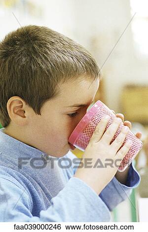 Child drinking from plastic cup, side view View Large Photo Image Stock Photograph - Child drinking from plastic cup, side view. Fotosearch