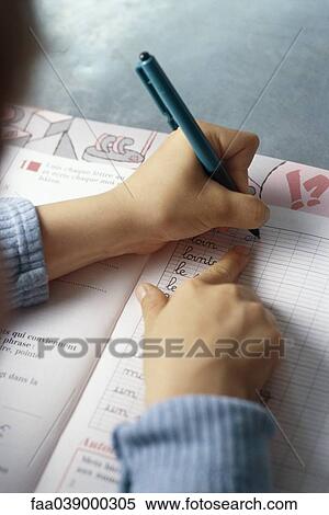 Stock Photography - Child practicing handwriting in notebook, cropped. Fotosearch