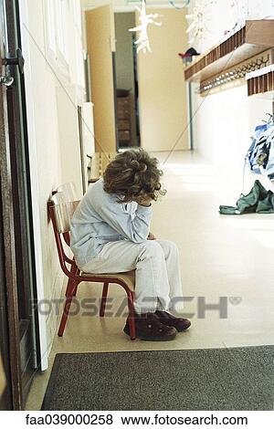 Child sitting alone in corridor, holding head View Large Photo Image Stock Photo - Child sitting alone in corridor, holding head. Fotosearch