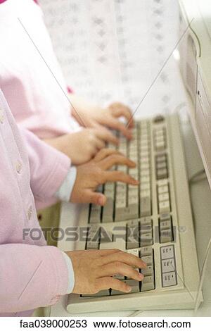 Children typing on keyboard, cropped view of hands View Large Photo Image Stock Image - Children typing on keyboard, cropped view of hands. Fotosearch