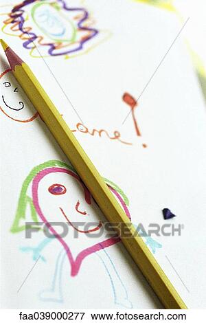 Stock Photo - Colored pencil resting on child's drawing, close-up. Fotosearch