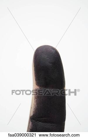 Stock Image - Finger covered with black paint. Fotosearch
