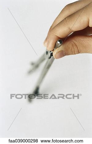 Hand holding drawing compass View Large Photo Image Stock Photo - Hand holding drawing compass. Fotosearch
