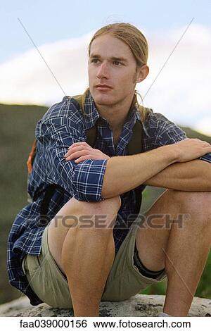 Stock Photograph - Hiker sitting, portrait. Fotosearch