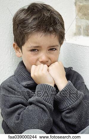Picture - Little boy crying, hands over mouth, portrait. Fotosearch