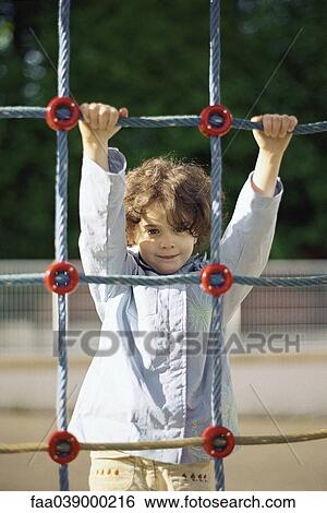 Little girl on rope climbing net, portrait View Large Photo Image Stock Photograph - Little girl on rope climbing net, portrait. Fotosearch
