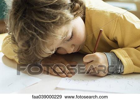 Little girl writing at desk View Large Photo Image Stock Photo - Little girl writing at desk. Fotosearch