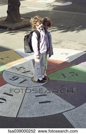 Little girls standing on hopscotch grid, portrait View Large Photo Image Stock Image - Little girls standing on hopscotch grid, portrait. Fotosearch