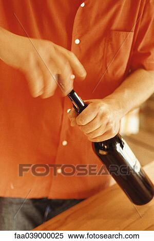Man opening wine bottle View Large Photo Image Stock Photography - Man opening wine bottle. Fotosearch