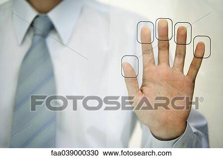 Stock Image - Man pressing fingertips to fingerprint reader. Fotosearch
