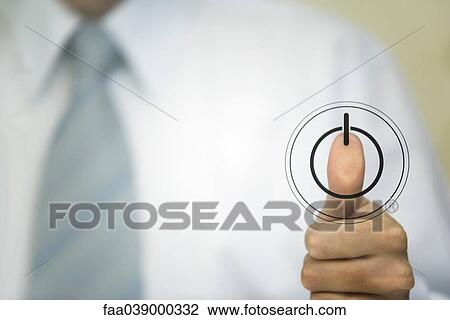 Stock Image - Man pressing thumb to power button. Fotosearch