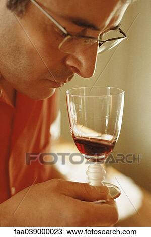 Man smelling red wine in wine glass View Large Photo Image Stock Image - Man smelling red wine in wine glass. Fotosearch