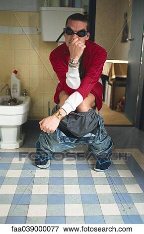 Stock Photo - Man using toilet, pinching nose. Fotosearch