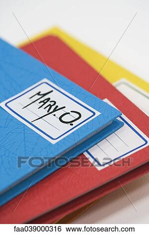 Pile of school notebooks with name written on label View Large Photo Image Stock Photograph - Pile of school notebooks with name written on label. Fotosearch