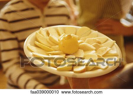Stock Image - Plate of sliced apples. Fotosearch