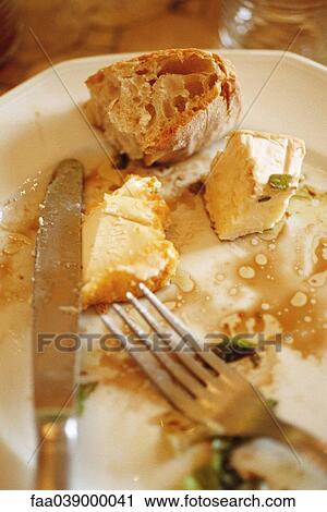 Plate with remnants of cheese and bread View Large Photo Image Stock Image - Plate with remnants of cheese and bread. Fotosearch