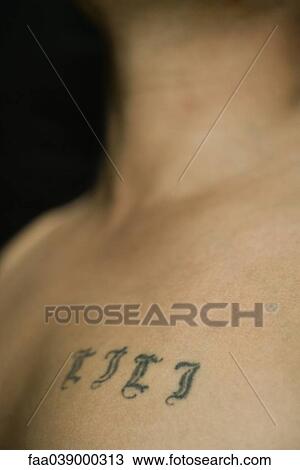 Tattooed letters on man's chest View Large Photo Image Stock Image - Tattooed letters on man's chest. Fotosearch
