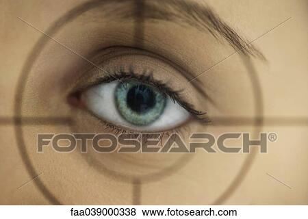 Stock Photo - Woman's eye behind gunsights. Fotosearch