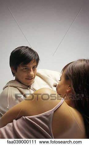 Young couple reclining, chatting View Large Photo Image Stock Image - Young couple reclining, chatting. Fotosearch