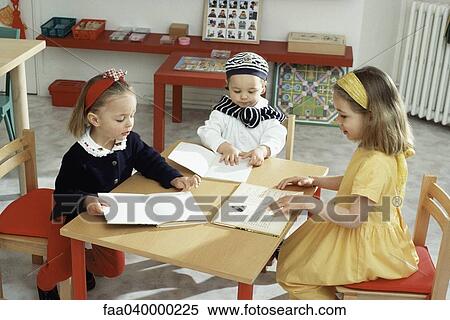 Children sitting around table with books View Large Photo Image Stock Photography - Children sitting around table with books. Fotosearch