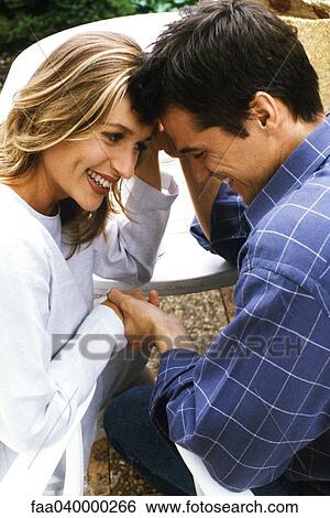 Couple holding hands and touching foreheads View Large Photo Image Stock Photograph - Couple holding hands and touching foreheads. Fotosearch
