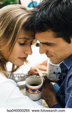 Couple touching foreheads over coffee View Large Photo Image Stock Photography - Couple touching foreheads over coffee. Fotosearch