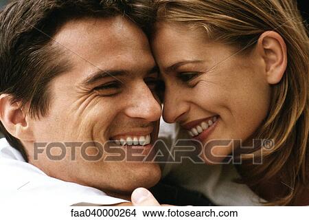 Couple touching foreheads, smiling at each other View Large Photo Image Picture - Couple touching foreheads, smiling at each other. Fotosearch